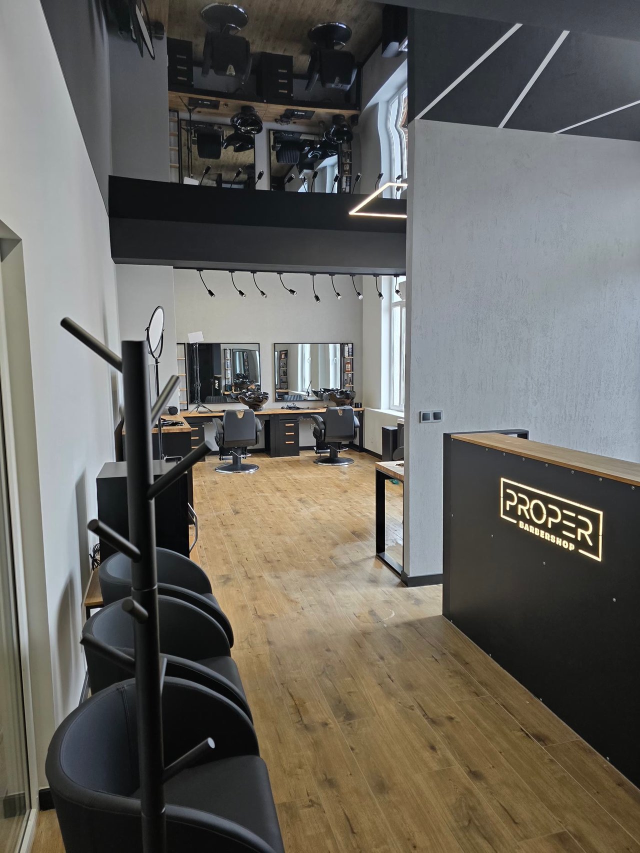 Puste fotele barberskie we wnętrzu Proper Barbershop